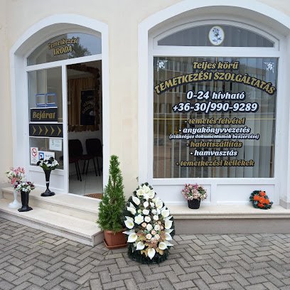 Temetkezési iroda bejárata, virágokkal és információkkal a szolgáltatásokról.