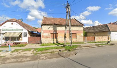 Temetkezési vállalkozás épülete falusi környezetben.