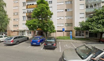 Temetkezési szolgáltató iroda épülete parkolóval.